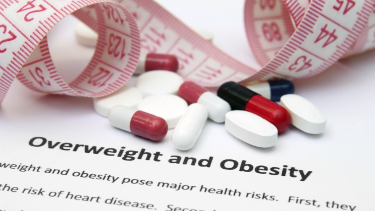 Oral weight loss pills with measuring tape illustrating shift in obesity treatment