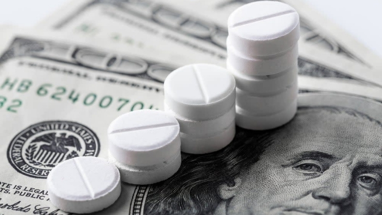 White tablets stacked on US dollar bill